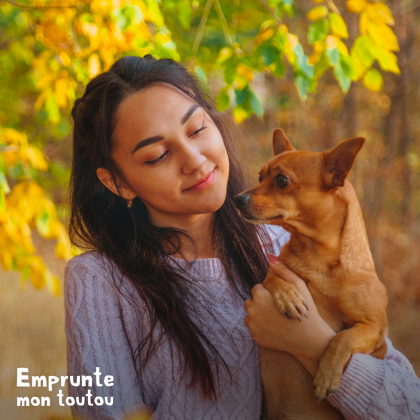 jeune femme tenant un chien dans ses bras