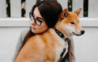 femme enlaçant un chien shiba inu